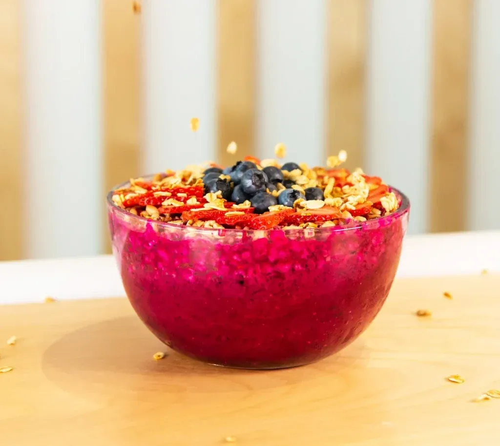 A pitaya bowl topped with granola, berries and goji